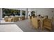 Covered patio with rattan seating around a dining table and other furniture, with a pool view at 227 S Harbor Dr, Holmes Beach, FL 34217