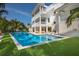 A beautiful pool with a beach entry, sun loungers, and an elevated spa is perfect for relaxation at 227 S Harbor Dr, Holmes Beach, FL 34217