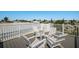 Rooftop deck boasts white railings and chairs, offering a relaxing outdoor space at 227 S Harbor Dr, Holmes Beach, FL 34217