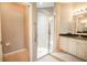 Full bathroom featuring walk-in shower, tan tiled floor, granite countertops, and a neutral-colored wall at 234 Padova Way, North Venice, FL 34275