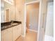 Bathroom featuring a granite countertop vanity, neutral walls, and a walk-in shower at 234 Padova Way, North Venice, FL 34275