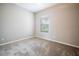 Bedroom showcasing a neutral wall color, carpeted floors, and a window at 234 Padova Way, North Venice, FL 34275