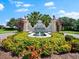 Elegant community entrance with decorative signage, lush landscaping and serene water features at 234 Padova Way, North Venice, FL 34275
