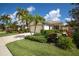 Charming single-story home boasts a well-manicured lawn, lush landscaping, and a welcoming two-car garage at 234 Padova Way, North Venice, FL 34275