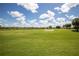 This is a beautiful view of the community golf course featuring blue skies and fluffy clouds at 234 Padova Way, North Venice, FL 34275