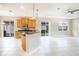 Bright kitchen and living area featuring tile floors, recessed lights, a ceiling fan, and a breakfast bar at 234 Padova Way, North Venice, FL 34275