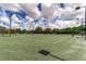Well-maintained tennis courts with lighting for evening play surrounded by lush landscaping at 234 Padova Way, North Venice, FL 34275