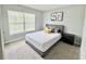 This bedroom features neutral walls, plush carpeting, a window, and a comfortable bed at 2425 Maclachlan St, Port Charlotte, FL 33953