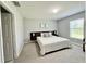 Comfortable bedroom with a queen bed, soft carpet, and natural light at 2425 Maclachlan St, Port Charlotte, FL 33953