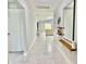 Hallway view showcasing tiled floors, decorative shelves, and an open view to the living room at 2425 Maclachlan St, Port Charlotte, FL 33953