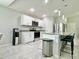 Well-equipped kitchen with stainless steel appliances, a bar, and a modern water dispenser at 2425 Maclachlan St, Port Charlotte, FL 33953