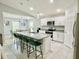 Spacious kitchen featuring a large island, granite countertops, stainless steel appliances, and white cabinets at 2425 Maclachlan St, Port Charlotte, FL 33953