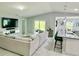 Comfortable living room with a large couch, TV, and an open layout leading to the dining area at 2425 Maclachlan St, Port Charlotte, FL 33953