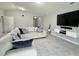 Cozy living room featuring a sectional sofa, wall-mounted TV, and modern decor at 2425 Maclachlan St, Port Charlotte, FL 33953
