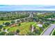 Aerial view of community park with lush green space, walking paths, sports fields, and residential homes in the background at 336 165Th Ne Ct, Bradenton, FL 34212
