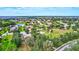 High angle view showing a neighborhood with a community park surrounded by houses, ponds, and green trees at 336 165Th Ne Ct, Bradenton, FL 34212