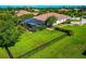 Expansive property featuring a large backyard with a screened-in pool, lush landscaping, and a black metal fence at 336 165Th Ne Ct, Bradenton, FL 34212