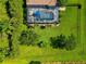 Aerial view of a home featuring a lush green yard, screened-in pool area, and well-maintained landscaping at 336 165Th Ne Ct, Bradenton, FL 34212