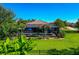 Lush backyard with a screened-in pool, mature trees, and well-maintained lawn, great for entertaining at 336 165Th Ne Ct, Bradenton, FL 34212