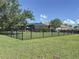 Spacious backyard with black metal fence, landscaped surroundings and screened in patio with pool at 336 165Th Ne Ct, Bradenton, FL 34212