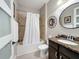 Full bathroom featuring a shower-tub combo with a white curtain and granite countertops at 336 165Th Ne Ct, Bradenton, FL 34212
