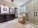 Relaxing bathroom featuring double sink vanity, soaking tub, and separate glass shower with tiled walls at 336 165Th Ne Ct, Bradenton, FL 34212
