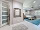 Elegant bedroom with tray ceiling, a ceiling fan, and a decorative accent wall at 336 165Th Ne Ct, Bradenton, FL 34212
