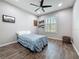 Comfortable bedroom provides abundant natural light, hardwood floors, and floating shelves creating a serene retreat at 336 165Th Ne Ct, Bradenton, FL 34212