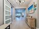 Inviting foyer featuring wood floors, a stylish sliding barn door, and an open view into the living and dining areas at 336 165Th Ne Ct, Bradenton, FL 34212