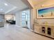 Welcoming foyer featuring light wood flooring, a decorative cabinet, and sightlines into the open-concept living spaces at 336 165Th Ne Ct, Bradenton, FL 34212