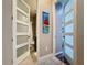 Hallway featuring paneled double doors with a glimpse into the nearby bathroom at 336 165Th Ne Ct, Bradenton, FL 34212