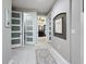 Hallway with doors leading to closet and bathroom, decorated with framed artwork at 336 165Th Ne Ct, Bradenton, FL 34212