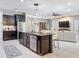 Open-concept kitchen with granite island, stainless appliances, and seamless flow to living area at 336 165Th Ne Ct, Bradenton, FL 34212