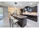 Large kitchen island with seating, dark cabinetry, granite countertops, and modern pendant lighting at 336 165Th Ne Ct, Bradenton, FL 34212