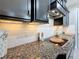 Modern kitchen features granite countertops, black cabinets, subway tile backsplash, and stainless steel appliances at 336 165Th Ne Ct, Bradenton, FL 34212