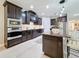 Beautiful kitchen with dark cabinets, granite countertops, subway tile backsplash, and modern stainless steel appliances at 336 165Th Ne Ct, Bradenton, FL 34212