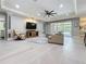 Cozy living room featuring tray ceilings, light wood floors, comfortable seating, and a view of the screened lanai at 336 165Th Ne Ct, Bradenton, FL 34212