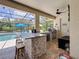 Enjoy outdoor living with this screened-in patio and a full kitchen, including a grill, sink, and bar seating at 336 165Th Ne Ct, Bradenton, FL 34212