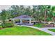 Community park pavilion with picnic tables, stone support pillars, and a walking path leading to the playground area at 336 165Th Ne Ct, Bradenton, FL 34212