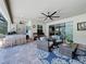 Inviting screened-in patio with a stone bar, comfortable seating, and a view through to the home's interior at 336 165Th Ne Ct, Bradenton, FL 34212