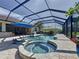 Beautiful screened-in pool and spa area featuring a built-in spa and lounge chairs, perfect for relaxation at 336 165Th Ne Ct, Bradenton, FL 34212