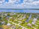 Beautiful aerial view of waterfront home with canal access and a large bay in the distance at 336 Highland Shores Dr, Ellenton, FL 34222