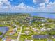 Picturesque aerial view of a waterfront home with boat dock and canal access to a large bay at 336 Highland Shores Dr, Ellenton, FL 34222