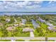 Picturesque aerial view of the waterfront home, lush backyard and canal access to the bay at 336 Highland Shores Dr, Ellenton, FL 34222