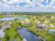 Stunning aerial view of waterfront home with lush backyard, dock, and canal access to a wide bay at 336 Highland Shores Dr, Ellenton, FL 34222