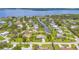 Gorgeous aerial view of a waterfront home with canal access, lush landscaping, and neighborhood at 336 Highland Shores Dr, Ellenton, FL 34222