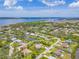 Aerial view of the waterfront property with a canal, situated in a scenic community with lush greenery and water views at 336 Highland Shores Dr, Ellenton, FL 34222