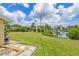 Lush backyard with green grass, landscaping, and waterfront access with boat dock at 336 Highland Shores Dr, Ellenton, FL 34222