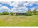 Expansive backyard featuring a well-maintained lawn and a screened-in porch, perfect for outdoor relaxation and entertainment at 336 Highland Shores Dr, Ellenton, FL 34222