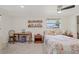 Cozy bedroom featuring a ceiling fan, window, neutral carpet, and a charming quilt at 336 Highland Shores Dr, Ellenton, FL 34222